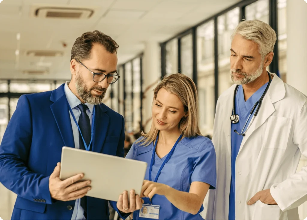 A hospital team collaborates using digital tools to enhance patient experience through personalized education and interactive engagement.