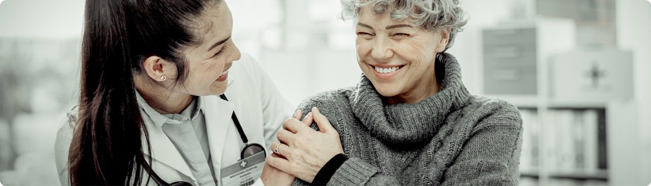 Doctor smiling and supporting a patient, illustrating the 4 Ps of patient experience in compassionate healthcare.Doctor smiling and supporting a patient, illustrating the 4 Ps of patient experience in compassionate healthcare.