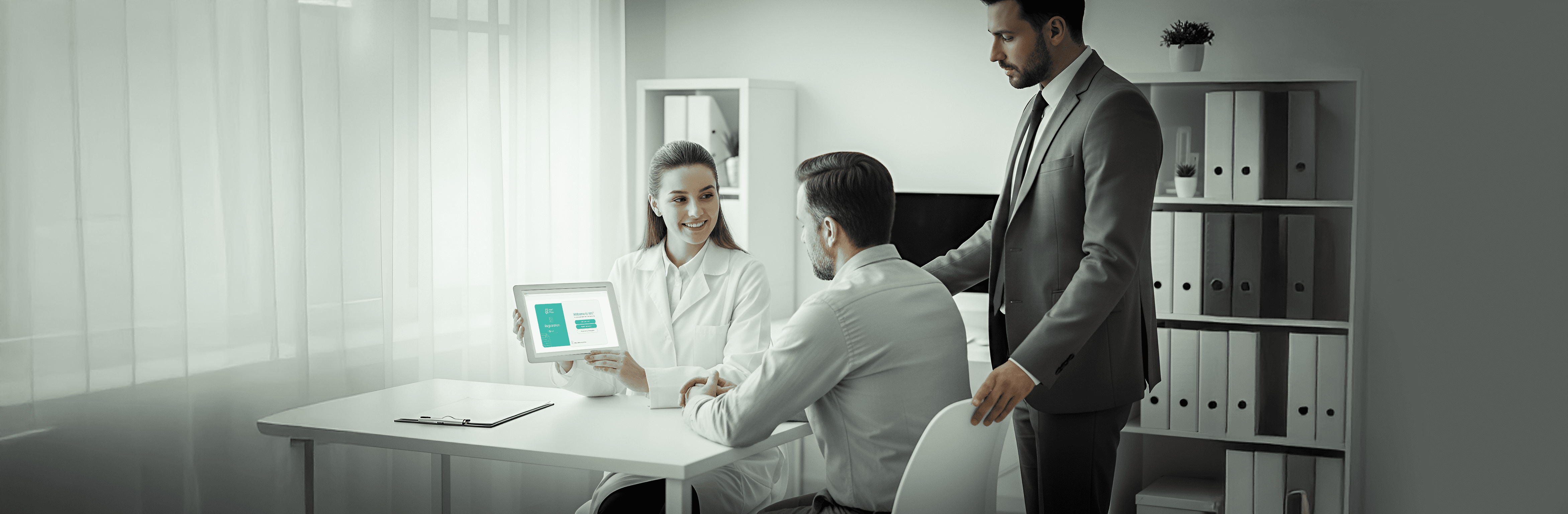patient in hospital recieving education from hcp, beside them a patient advocacy specialist ensuring that the patient recieve his right