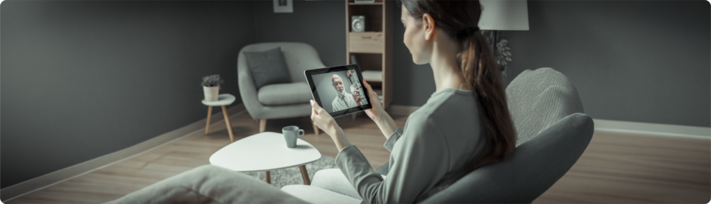 Patient attending a virtual doctor consultation from home using a tablet, demonstrating telemedicine and digital transformation in health care for remote patient care and accessibility